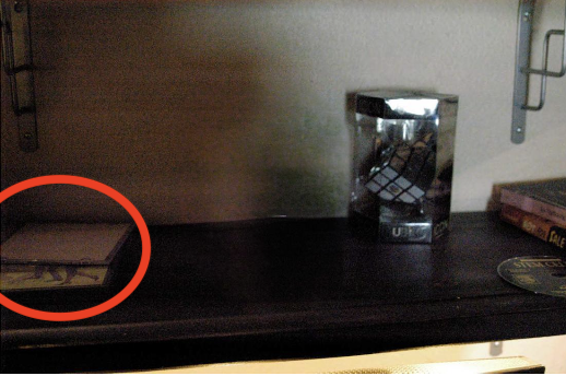 Reconstruction — 2 CDs of unknown origin placed on shelf, slightly offset